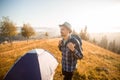 Handsome bearded man tourist exploring new places on top of mountains. Hiker man in hat with backpack