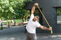 Handsome bearded man training with resistance band at the park Royalty Free Stock Photo