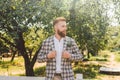 Handsome bearded man in vintage clothing. Portrait stylish groom in plaid jacket on his wedding day in the park. Rustic Royalty Free Stock Photo