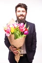 Handsome bearded man wearing in suit, with beard and nice bouquet of flowers