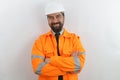 Handsome bearded man wearing worker uniform and hardhat happy face smiling with crossed arms looking at the camera. Royalty Free Stock Photo