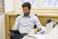 Handsome bearded man working in office on computer