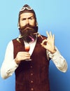 Funny handsome bearded pilot on blue studio background Royalty Free Stock Photo