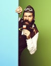 Funny handsome bearded pilot on blue green studio background Royalty Free Stock Photo