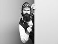 Handsome bearded pilot or aviator man with long beard and mustache on serious face holding glass of alcoholic beverage Royalty Free Stock Photo