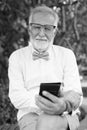 Handsome bearded senior tourist man exploring the city in black and white Royalty Free Stock Photo