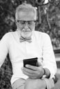 Handsome bearded senior tourist man exploring the city in black and white Royalty Free Stock Photo