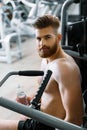 Handsome bearded sportsman in gymnasium