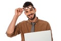 Bearded teacher holding eyeglasses and laptop while smiling at camera isolated on white