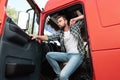 Handsome bearded truck driver inside his red cargo truck Royalty Free Stock Photo