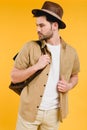 handsome bearded young man in hat holding backpack and looking away Royalty Free Stock Photo