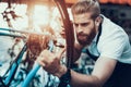 Handsome Bike Mechanic Repair Bicycle in Workshop