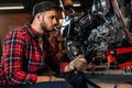 handsome bike repair station worker with wrench looking