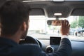 Handsome bisnessman behind the wheel adjusting rear view mirror. Royalty Free Stock Photo