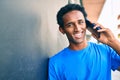 Handsome black african man smiling happy outdoors speaking on the phone Royalty Free Stock Photo