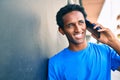 Handsome black african man smiling happy outdoors speaking on the phone Royalty Free Stock Photo