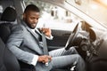 Handsome black businessman fasten seat belt in his car Royalty Free Stock Photo