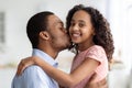 Handsome black father kissing his cute little daughter Royalty Free Stock Photo