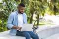 Handsome Aferican American Freelancer Guy Working On Laptop In Park Royalty Free Stock Photo