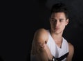 Handsome black haired young man on dark background