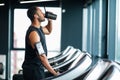 Handsome Black Male Athlete Drinking Water While Training At Treadmill At Gym Royalty Free Stock Photo