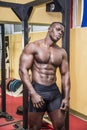 Handsome black male bodybuilder resting after workout in gym