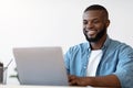 Handsome Black Male Office Employee Working On Laptop Computer, Closeup Shot Royalty Free Stock Photo