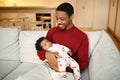 Handsome black man father holding his sleeping child cute baby Royalty Free Stock Photo