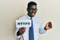 Handsome black man holding https privacy url screaming proud, celebrating victory and success very excited with raised arm Royalty Free Stock Photo