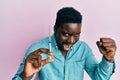 Handsome black man holding syringe screaming proud, celebrating victory and success very excited with raised arms Royalty Free Stock Photo