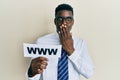 Handsome black man holding www on paper covering mouth with hand, shocked and afraid for mistake Royalty Free Stock Photo