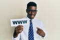 Handsome black man holding www on paper smiling happy pointing with hand and finger Royalty Free Stock Photo