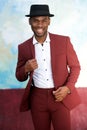 Handsome black man smiling in vintage suit and hat