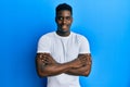 Handsome black man wearing casual white t shirt happy face smiling with crossed arms looking at the camera Royalty Free Stock Photo