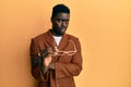 Handsome black man wearing elegant clothes and glasses clueless and confused expression Royalty Free Stock Photo