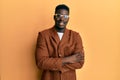 Handsome black man wearing elegant clothes and glasses happy face smiling with crossed arms looking at the camera Royalty Free Stock Photo