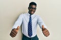 Handsome black man wearing glasses business shirt and tie approving doing positive gesture with hand, thumbs up smiling and happy Royalty Free Stock Photo