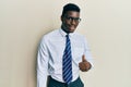 Handsome black man wearing glasses business shirt and tie doing happy thumbs up gesture with hand Royalty Free Stock Photo