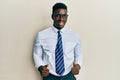 Handsome black man wearing glasses business shirt and tie success sign doing positive gesture with hand, thumbs up smiling and Royalty Free Stock Photo