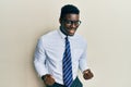 Handsome black man wearing glasses business shirt and tie very happy and excited doing winner gesture with arms raised, smiling Royalty Free Stock Photo