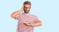 Handsome blond man with beard wearing casual clothes and glasses looking at the watch time worried, afraid of getting late Royalty Free Stock Photo