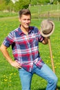 Blond man at farmland holdiing pitchfork