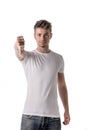 Handsome blond young man doing thumb down sign Royalty Free Stock Photo