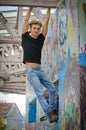 Handsome blond young man hanging from concrete structure Royalty Free Stock Photo