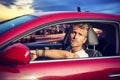 Handsome blond young man sitting in his car Royalty Free Stock Photo