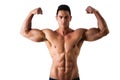 Handsome bodybuilder doing biceps pose, isolated