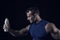 Handsome bodybuilder man with muscular body holds drink bottle Royalty Free Stock Photo