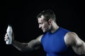 Handsome bodybuilder man with muscular body holds drink bottle Royalty Free Stock Photo