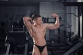 Handsome bodybuilder posing in gym, perfect muscular male body Royalty Free Stock Photo