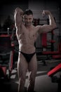 Handsome bodybuilder posing in gym. Perfect muscular male body Royalty Free Stock Photo